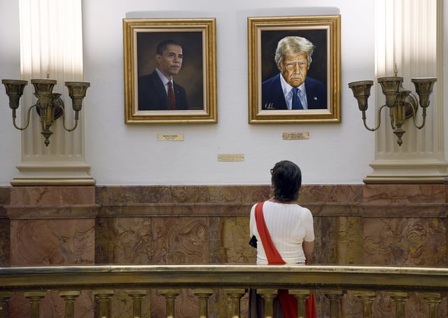 A visitor looks at a portrait of President Donald Trump in the Colorado State Capitol in Denver on Tuesday, July 1, 2025.(AP Photo/Thomas Peipert)