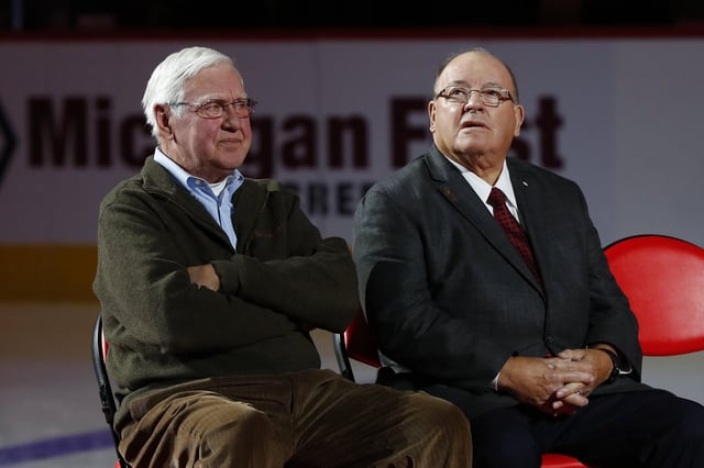 FILE - Former Detroit Red Wings player Alex Delvecchio, left, and former head coach Scotty Bowman listen during a ceremony to retire Red Kelly's number 4 before an NHL hockey game against the Toronto Maple Leafs, Feb. 1, 2019, in Detroit. (AP Photo/Paul Sancya, File)