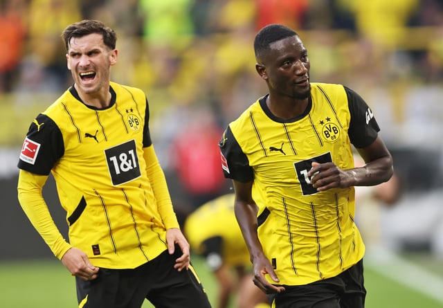 Serhou Guirassy of Borussia Dortmund celebrates scoring his team&#39;s first goal with teammate Pascal Gross during the Bundesliga match between Borussia Dortmund and Borussia Mönchengladbach at Signal Iduna Park on April 20, 2025, in Dortmund, Germany.