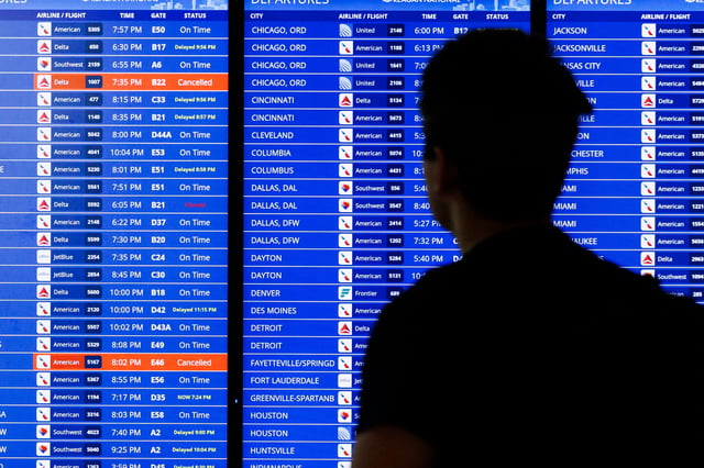 A flight departure information board can be seen on Tuesday July 23, 2024, at Ronald Reagan Airport in Arlington, Virginia. (Photo by Aaron Schwartz / Middle East Images / Middle East Images via AFP) (Photo by AARON SCHWARTZ/Middle East Images/AFP via Getty Images)