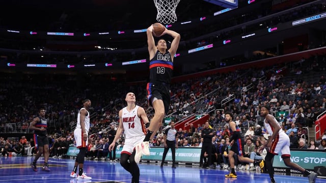 Simone Fontecchio of the Detroit Pistons dunks in the Nike Freak 6 NRG EP ‘Roses’ in front of Tyler Herro of the Miami Heat in the Nike Sabrina 2 ‘By You’ during the second half in the first round of the Emirates NBA Cup at Little Caesars Arena