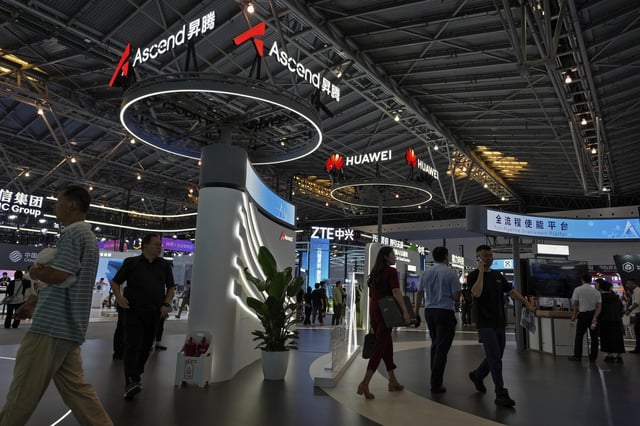 FILE - People visit the Ascend AI exhibition booth by Huawei during the 2024 The World Artificial Intelligence Conference (WAIC) & High-Level Meeting on Global AI Governance with the theme "Governing AI for Good and for All" at the Shanghai Expo Center Multifunction Hall in Shanghai China on July 4, 2024. (AP Photo/Andy Wong, File)