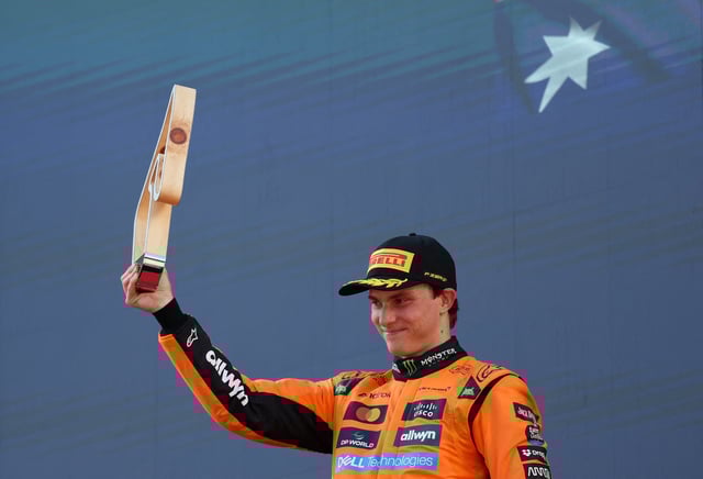 Formula One F1 - Austrian Grand Prix - Red Bull Ring, Spielberg, Austria - June 29, 2025 McLaren's Oscar Piastri celebrates with a trophy on the podium after finishing second in the Austrian Grand Prix REUTERS/Gintare Karpaviciute