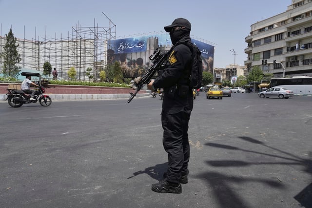 A member of Iran&#39;s Revolutionary Guard stands guard at Enqelab-e-Eslami (Islamic Revolution) square in downtown Tehran, Iran, Tuesday, June 24, 2025.