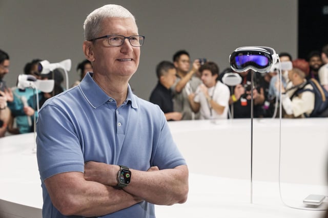 Tim Cook, chief executive officer of Apple Inc., beside an Apple Vision Pro mixed reality (XR) headset during the Apple Worldwide Developers Conference at Apple Park campus in Cupertino, California, US, on Monday, June 5, 2023.