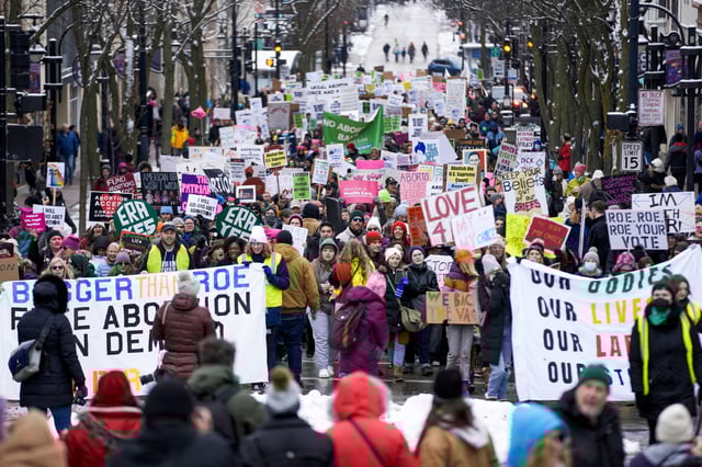 Protesters make their way to the Wisconsin Capitol Rotunda during a march supporting overturning Wisconsin's near total ban on abortion on Jan. 22, 2023, in Madison, Wis.
