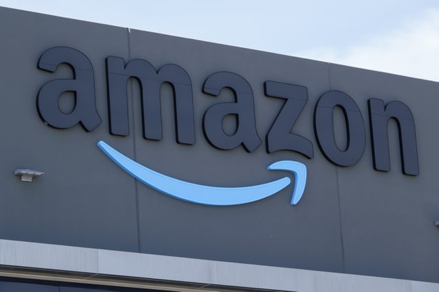 An Amazon logo is displayed outside an Amazon Delivery Station on April 25, 2025 in San Diego, California.