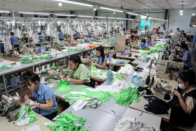 Vietnamese garment factory workers stitch apparel at a factory in Ho Chi Minh City.