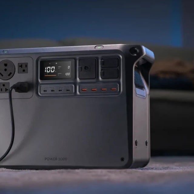 the DJI power 2000 portable power station in a dimly lit room