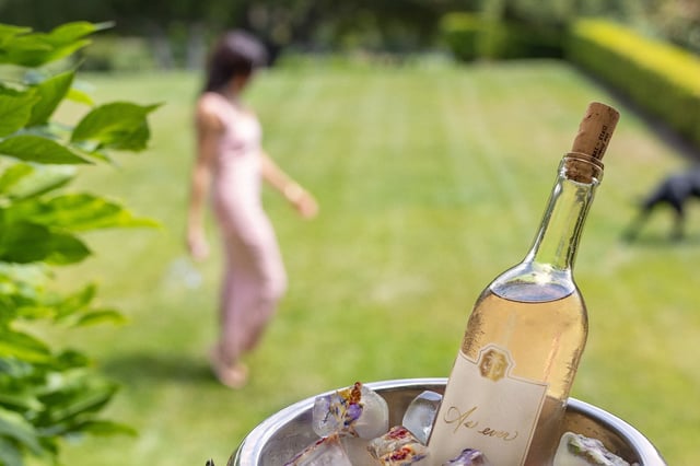 Meghan Markle poses with her Napa Valley rosé wine in a publicity image released by her As Ever online shop.