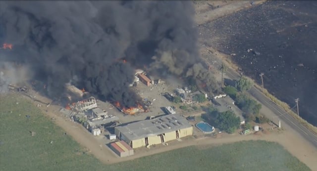 Smoke and flames rise  at a fireworks warehouse near Esparto, Calif., on Tuesday, July 1, 2025.  (KGO via AP)