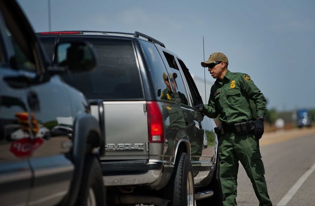 U.S. Border Patrol agents check vehicles at the Eagle Pass/Carrizo Springs checkpoint near Eagle Pass in this file photo. A San Antonio man was sentenced to 10 years in prison for smuggling 25 undocumented migrants into the country using a tanker trailer.