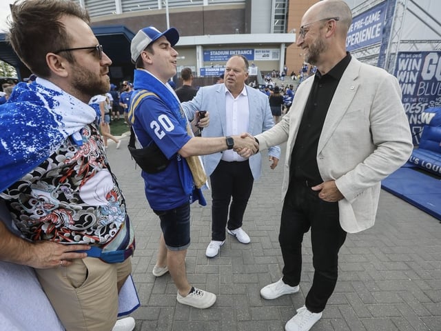 Stewart Johnston, CFL Commissioner, right, and Wade Miller, president and CEO of the Winnipeg Blue Bombers, talks with Winnipeg Blue Bomber fans at a "tail gate party" area prior to the Blue Bombers and Edmonton Elks game in Winnipeg, Thursday, June 26, 2025.
