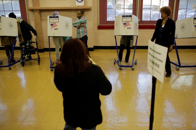 A voter casts his ballot behind a ballot booth during the U.S. presidential election at a polling station in the Bronx Borough of New York, U.S. on November 8, 2016. REUTERS/Saul Martinez