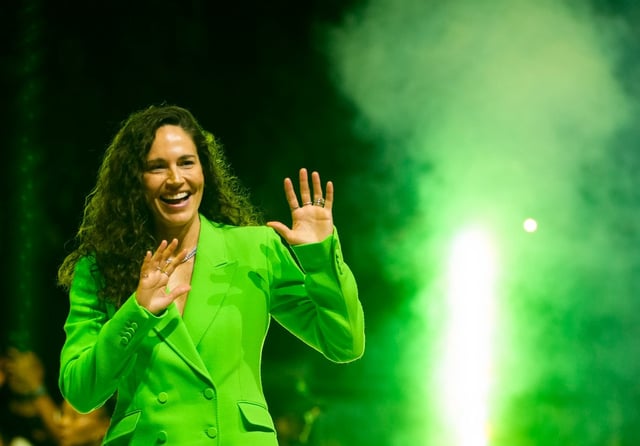 Former Seattle Storm guard Sue Bird waves as she enters the court during her jersey retirement ceremony following a WNBA basketball game between the Storm and the Washington Mystics, Sunday, June 11, 2023, in Seattle. (AP Photo/Lindsey Wasson)