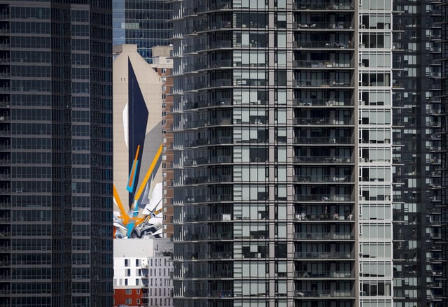 The Calgary Real Estate Board says home sales in the city decreased 16.5 per cent in June compared with last year as higher levels of new listings led to inventory gain. Internationally renowned graffiti artist Mirko Reisser's creation of the world's tallest mural is seen through high-rises in Calgary, Alta., Tuesday, June 28, 2022.THE CANADIAN PRESS/Jeff McIntosh