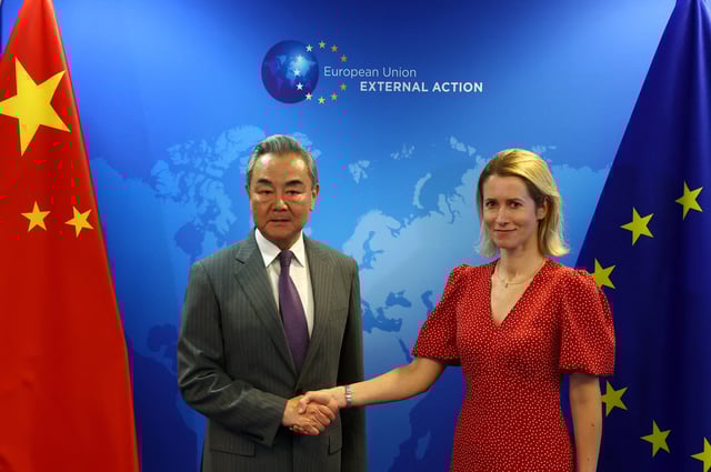 EU High Representative for Foreign Affairs and Security Policy and Vice-President of the European Commission Kaja Kallas shakes hands with Chinese Foreign Minister Wang Yi in Brussels, Belgium July 2, 2025. REUTERS/Yves Herman