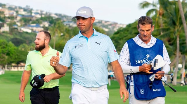 Pro golfer Gary Woodland, center, acknowledges the crowd as he’s walking off the 18th green after the second round of the Sony Open at Waialae Country Club in Hawaii.