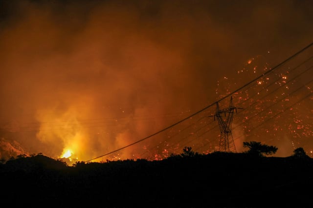 Flames rise as a wildfire burns near Ierapetra, on the island of Crete, Greece, July 2, 2025. REUTERS/Stefanos Rapanis