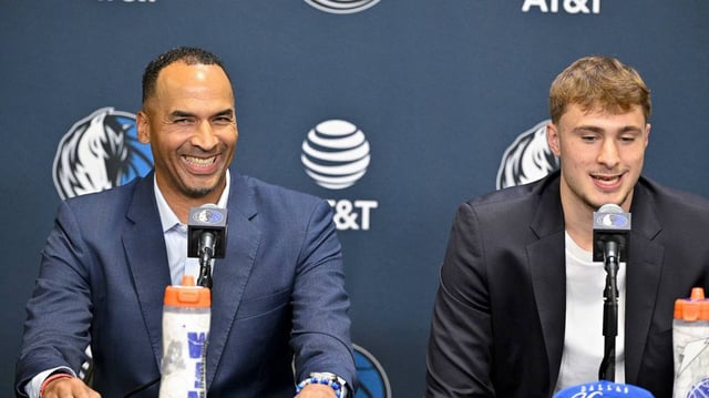 Jun 27, 2025; Dallas, TX, USA; Dallas Mavericks general manager Nico Harrison (left) looks on with Mavericks first overall pick Cooper Flagg (right) at a press conference at the Dallas Mavericks Practice Facility.