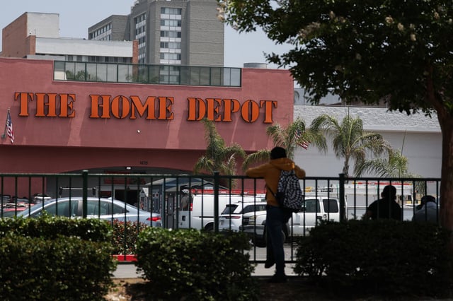 People wait outside of a Home Depot store on Wilshire Blvd that was previously the site of Immigration and Customs Enforcement (ICE) detention of day laborers in the Westlake MacArthur Park neighborhood of Los Angeles, California, on June 11, 2025. 