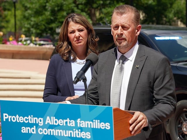 Mike Ellis, Minister of Public Safety and Emergency Services speaks to media Wednesday as Alberta Premier Danielle Smith looks on. Ellis spoke at a press conference announcing the new chief of the Independent Agency Police Service, a new policing option to carry out the current police duties of Alberta Sheriffs. 