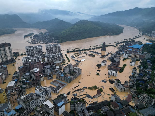 A drone view shows buildings and roads are half submerged in floodwaters after heavy rainfalls, in Rongjiang county, Guizhou province, China June 24, 2025. China Daily via REUTERS ATTENTION EDITORS - THIS IMAGE WAS PROVIDED BY A THIRD PARTY. CHINA OUT. NO COMMERCIAL OR EDITORIAL SALES IN CHINA. REFILE - CORRECTING FROM "GUIZHOUG TO GUIZHOU"/File Photo