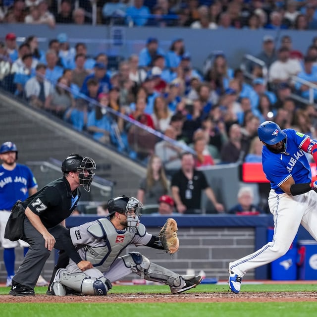 Toronto Blue Jays' Vladimir Guerrero Jr. (27) hits a two-run single against the New York Yankees during sixth inning MLB baseball action, in Toronto on Monday, June 30, 2025. THE CANADIAN PRESS/Thomas Skrlj