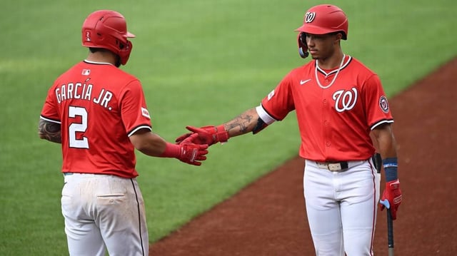 Jul 2, 2025; Washington, District of Columbia, USA; Washington Nationals second baseman Luis Garcia Jr. (2) celebrates with right fielder Daylen Lile (51) after scoring a run against the Detroit Tigers during the first inning at Nationals Park. Mandatory Credit: Rafael Suanes-Imagn Images