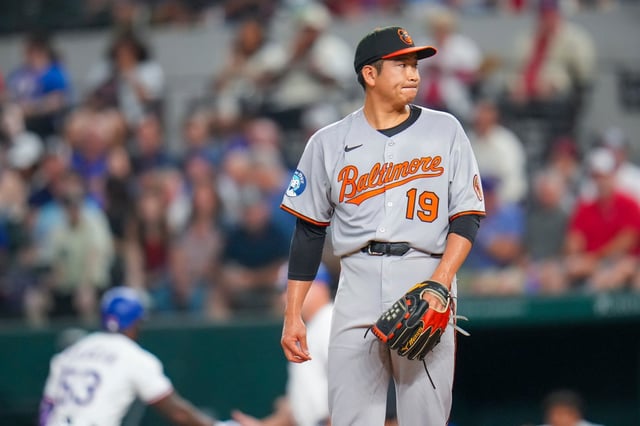 Baltimore Orioles starting pitcher Tomoyuki Sugano reacts after giving up a single to Texas Rangers&#39; Adolis García during the third inning of a baseball game Wednesday, July 2, 2025, in Arlington, Texas. (AP Photo/Julio Cortez)