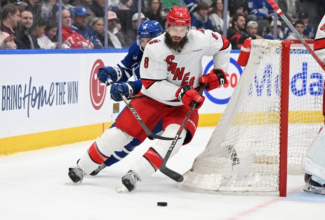 Feb 22, 2025; Toronto, Ontario, CAN;  Carolina Hurricanes defenseman Brent Burns (8) carries the puck away from Toronto Maple Leafs forward John Tavares (91) in the third period at Scotiabank Arena. Mandatory Credit: Dan Hamilton-Imagn Images/File Photo