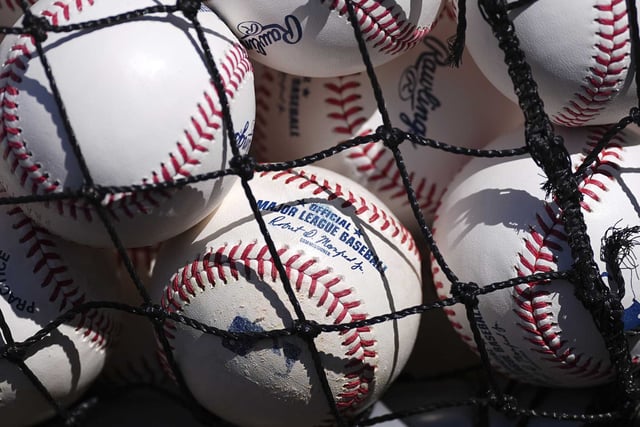 Practice baseballs sit in a basket before a baseball game between the Houston Astros and Colorado Rockies, Wednesday, July 2, 2025, in Denver. (AP Photo/David Zalubowski)