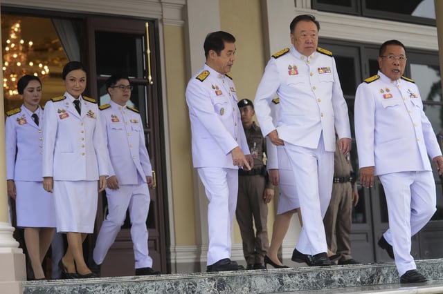 Thailand's acting Prime Minister Suriya Jungrungruangkit, fourth, from left leaves Government House with his new cabinet to take new cabinet oath in front of Thailand's King Maha Vajiralongkorn and Queen Suthida in Bangkok, Thailand, Thursday, July 3, 2025. (AP Photo/Sakchai Lalit)