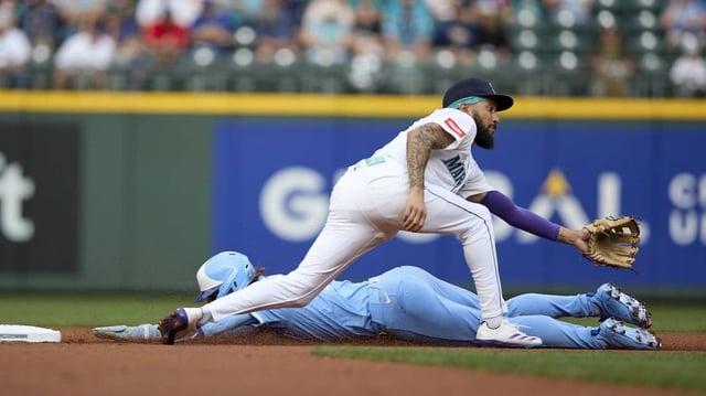Jul 2, 2025; Seattle, Washington, USA; Kansas City Royals shortstop Bobby Witt Jr. (7) steals second as Seattle Mariners shortstop J.P. Crawford (3) waits for the throw at T-Mobile Park. Mandatory Credit: John Froschauer-Imagn Images