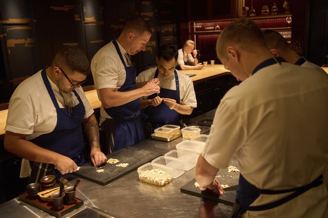 Executive chef Torsten Vildgaard, left center, and his staff chop nuts at FZN Restaurant on Palm Jumeirah in Dubai, United Arab Emirates, Friday, June 13, 2025. (AP Photo/ Fatima Shbair)