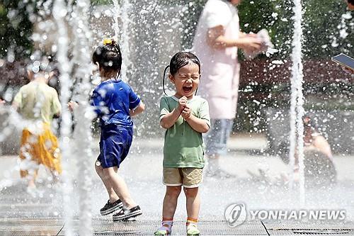 Children try to cool down at a public fountain in the southwestern city of Gwangju on July 2, 2025, in this photo released by the city's Buk Ward office. (PHOTO NOT FOR SALE) (Yonhap)