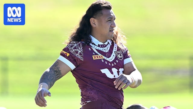 Josh Papali'i stretches at a Maroons State of Origin training session.