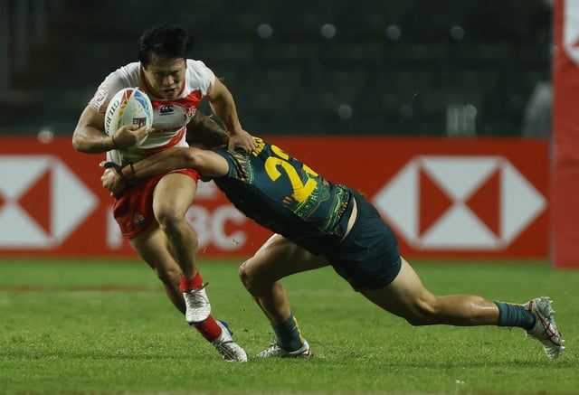 Rugby Union - Sevens World Cup - Day One - Hong Kong - March 31, 2023 Japan's Kippei Ishida in action with Australia's Darby Lancaster REUTERS/Tyrone Siu