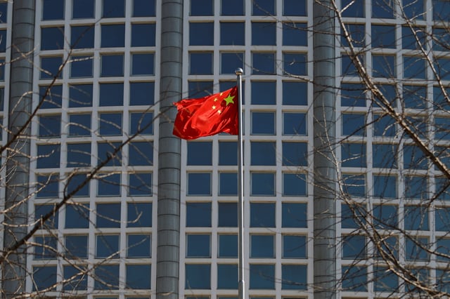 A Chinese flag flutters outside the Chinese foreign ministry in Beijing, China February 24, 2022. REUTERS/Carlos Garcia Rawlins