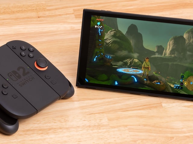 A Nintendo Switch 2 in standalone mode sitting next to the Joy-Con controller grip