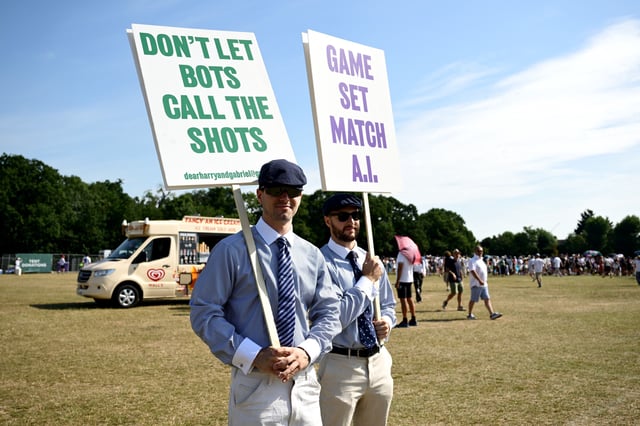 People dressed as line judges make their feelings known about the blanket use of electronic line calling at Wimbledon.