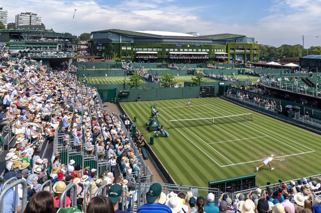 LONDON, ENGLAND - JULY 01: A general panoramic view of Wimbledon packed with spectators, with a back-drop of Centre Court, as Clara Tauson of Denmark plays against Heather Watson of Great Britain in the first round of the Ladies' Singles Competition on No.12 Court during the Wimbledon Lawn Tennis Championships at the All England Lawn Tennis and Croquet Club at Wimbledon on July 1st, 2025, in London, England. (Photo by Tim Clayton/Getty Images)
