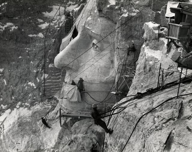 Men work on the face of Jefferson at Mount Rushmore in South Dakota, during the 1940s.
