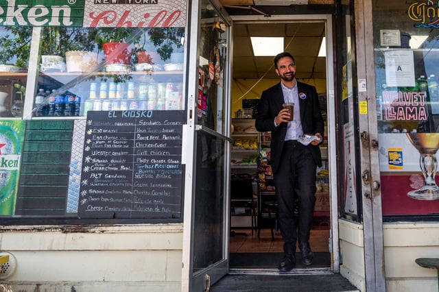 Zohran Mamdani, New York City mayoral candidate, walks out of a deli with an iced coffee after a campaign event in the Queens borough of New York on June 19, 2025.