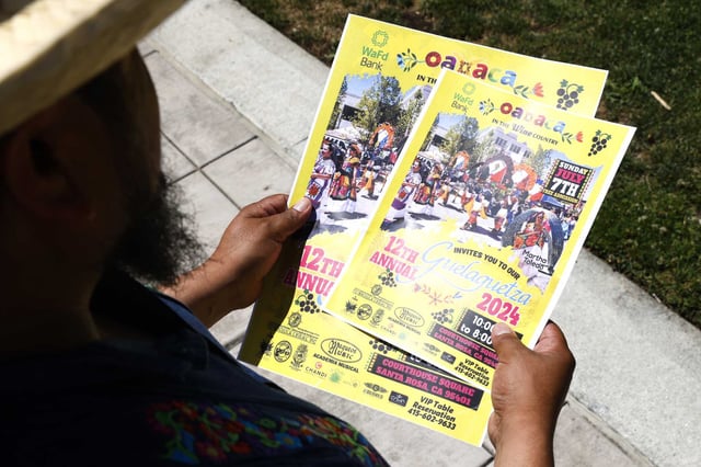 Felix Ortiz holds posters for last year’s Oaxaca in the Wine Country festival.