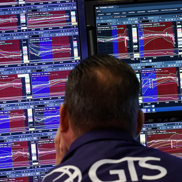 A trader works on the floor at the New York Stock Exchange (NYSE) in New York City, U.S., June 30, 2025.
