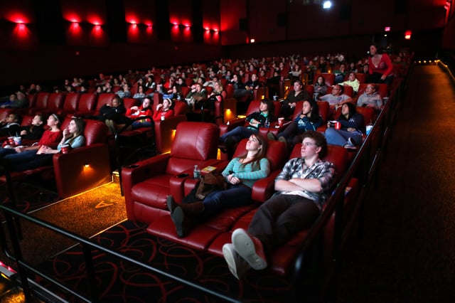 BRAINTREE, MA – NOVEMBER 23: Kerri Donaghue, left,  and Jack Hennessy, right, relax in all powered recliner seats at AMC Movie Theater in Braintree. (Photo by Jonathan Wiggs/The Boston Globe via Getty Images)