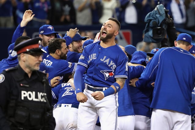 TORONTO, ON - OCTOBER 04: Kevin Pillar #11 of the Toronto Blue Jays celebrates defeating the Baltimore Orioles 5-2 in the eleventh inning to win the American League Wild Card game at Rogers Centre on October 4, 2016 in Toronto, Canada.