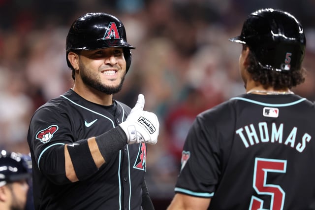PHOENIX, ARIZONA - JULY 10: Eugenio Suárez #28 of the Arizona Diamondbacks gives a thumbs up to Alek Thomas #5 after hitting a two run home run against the Atlanta Braves during the second inning at Chase Field on July 10, 2024 in Phoenix, Arizona.