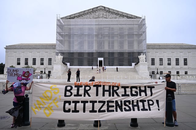 Demonstrators holds up an anti-Trump sign outside the US Supreme Court in Washington, DC, on June 27, 2025.